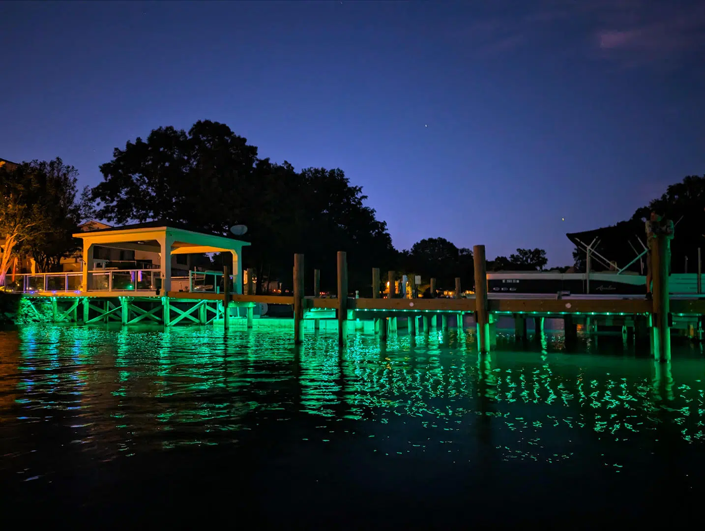 Bright green underwater and dock lighting along the waterfront in Tarpon Springs.