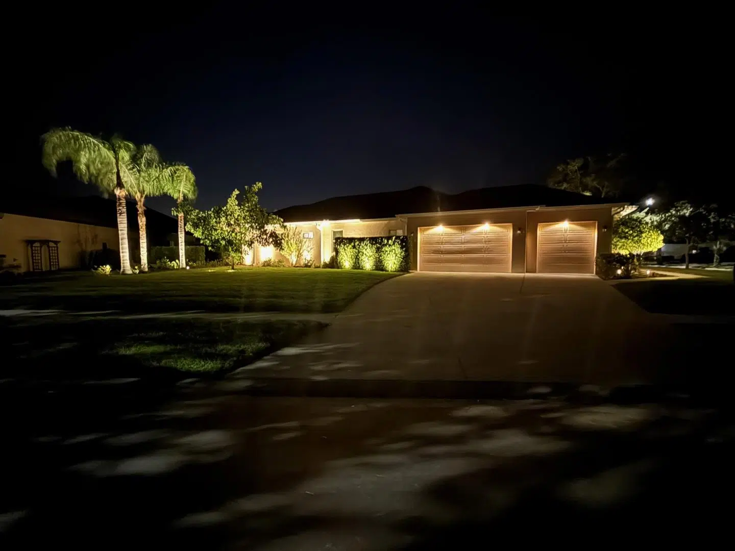 Subtle pathway and driveway lighting in a quiet Cheval neighborhood.