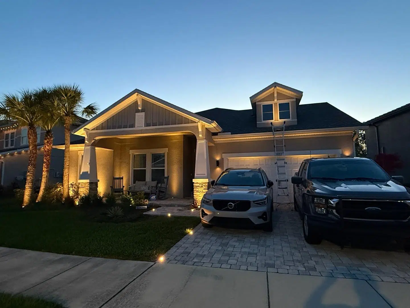 Clean lighting setup on the front porch and walkway of a Keystone home at sunset.