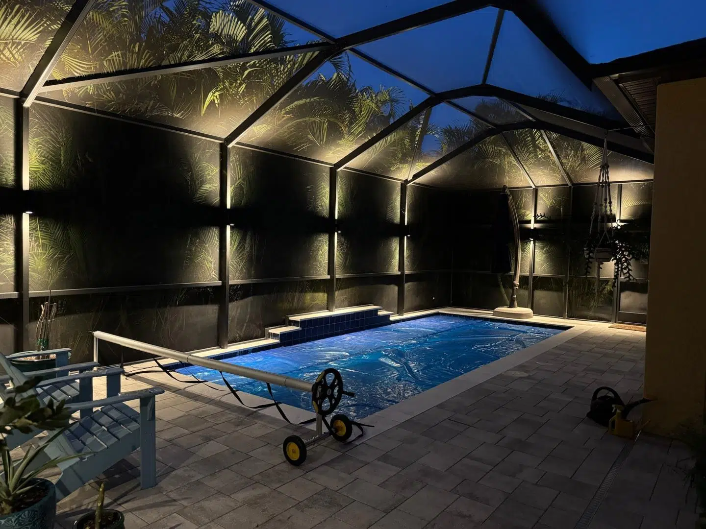 Golden LED lighting around a screened-in pool and patio in Lutz.